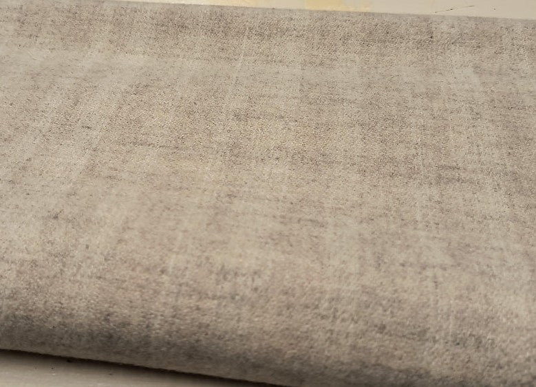 a close-up view of a grey fabric or material, possibly a piece of clothing or a textile.